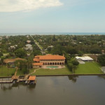 Aerial view from the riverside of the Indialantic estate with Atlantic Ocean in the background.