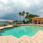 The Indialantic Estate home's pool views & outdoor kitchen area