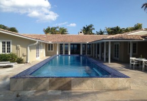 The great courtyard is a designer lap pool and the patio with travertine tiles welcomes you into the wide front entrance to the Vero Beach oceanfront house