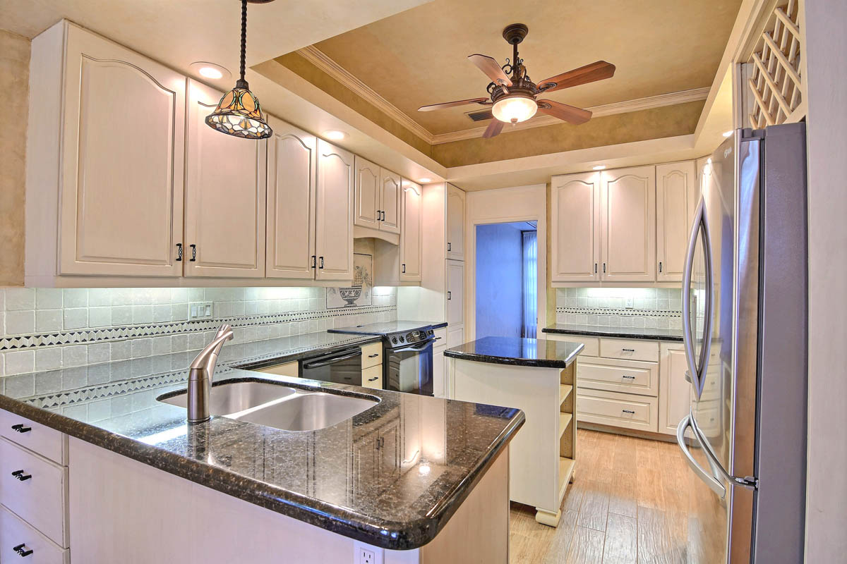 Kitchen granite countertops, custom mosaic inlay in backsplash and view into the formal dining room.                  