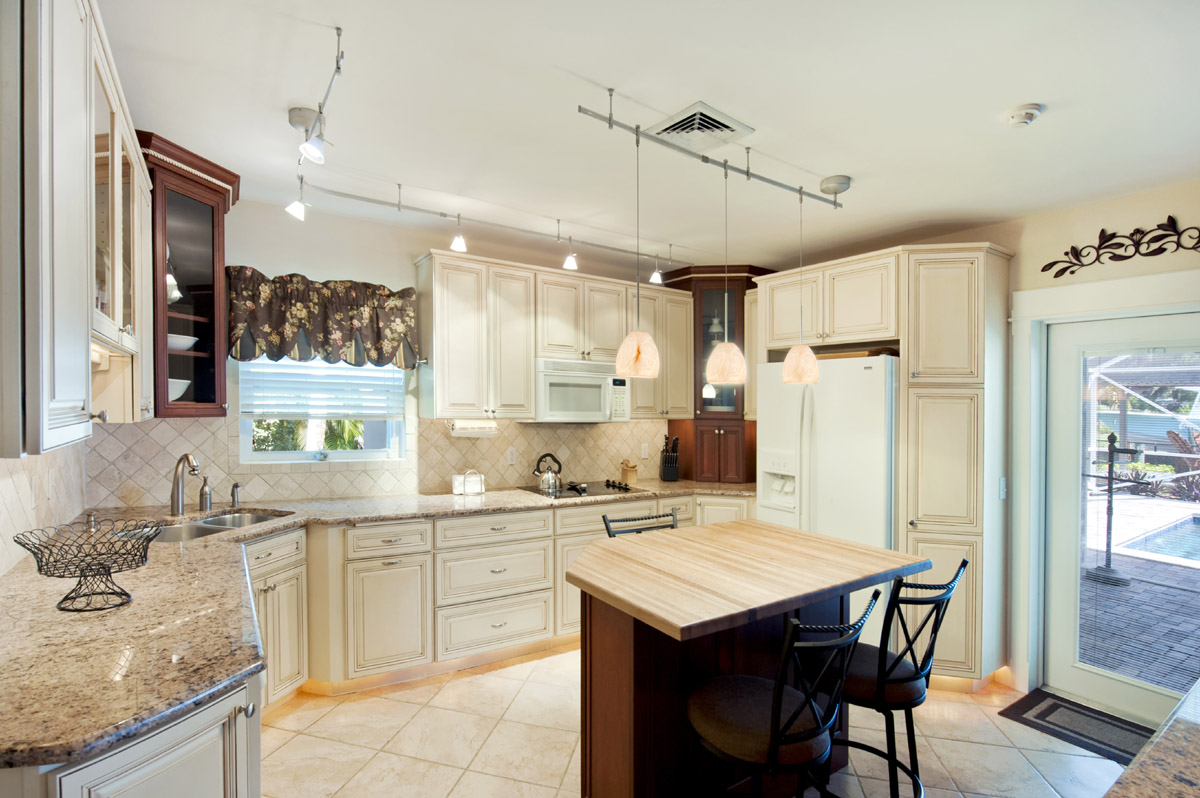 The well equipped kitchen opens up to the pool patio 