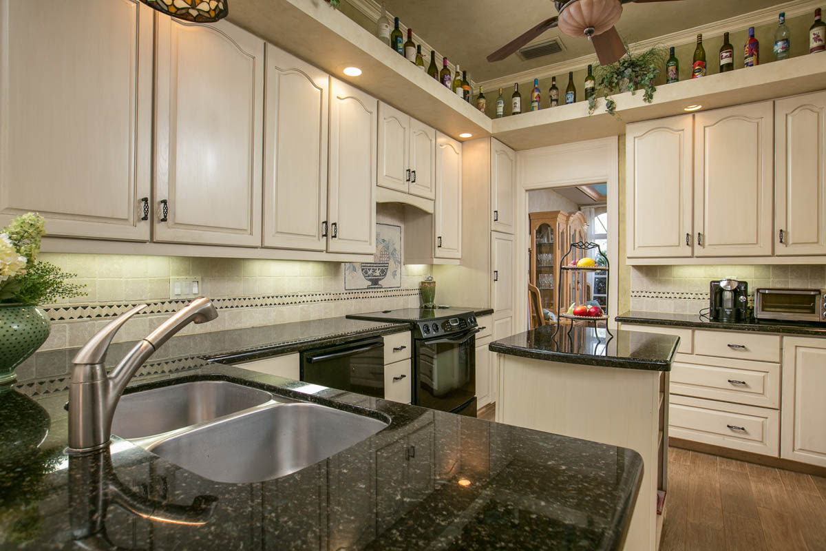 The kitchen backsplash features a custom mosaic over the cooktop.     