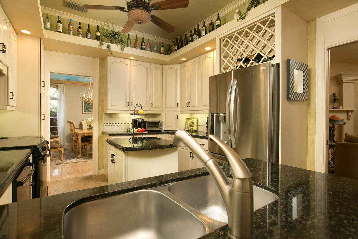 Another view of the kitchen and the adjacent formal dining room.     