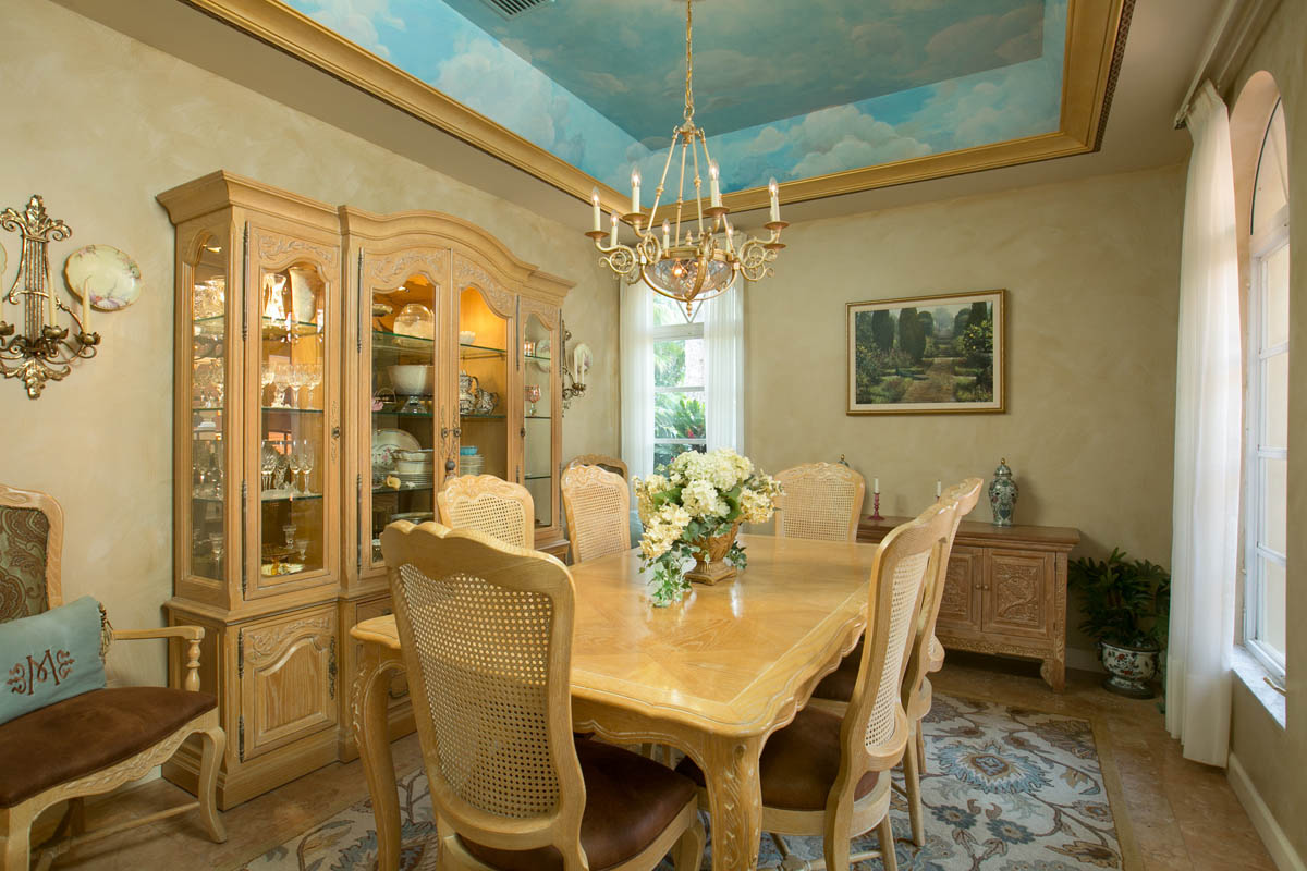 The beautifully painted formal dining room with a sky ceiling mural provides a great atmosphere for those special occasions.     