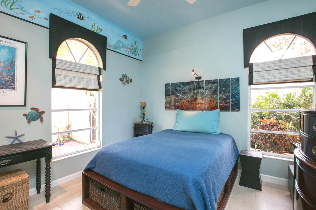 The 3rd bedroom with an accent sea life mural with garden views.                    