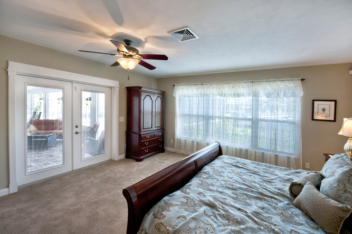 The Master Bedroom opens up to the pool patio with water view 