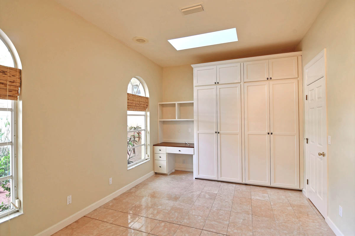 A large fourth bedroom that can be a den or an office with skylight and custom closet with attached desk.               