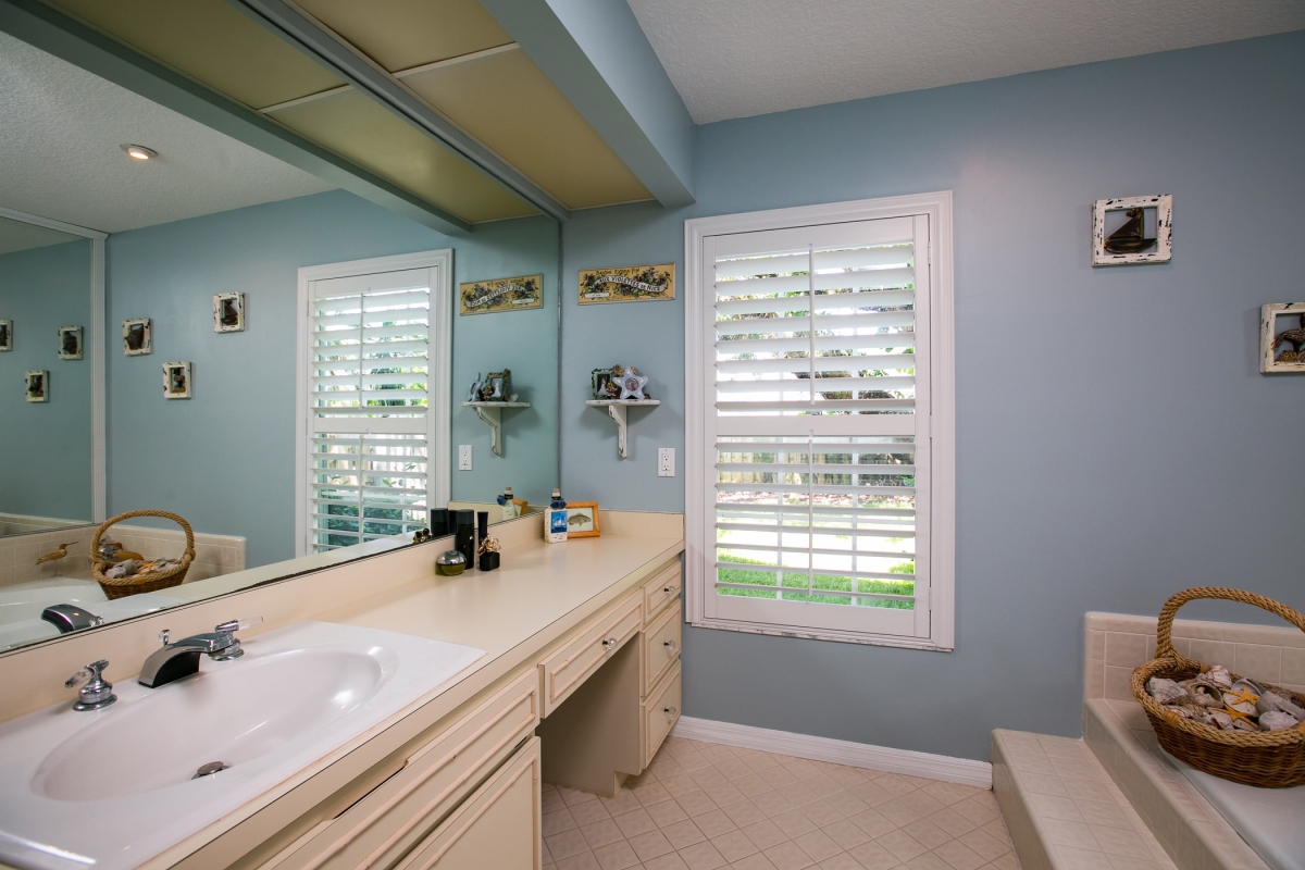 The master bath with his and hers sinks and roman tub 