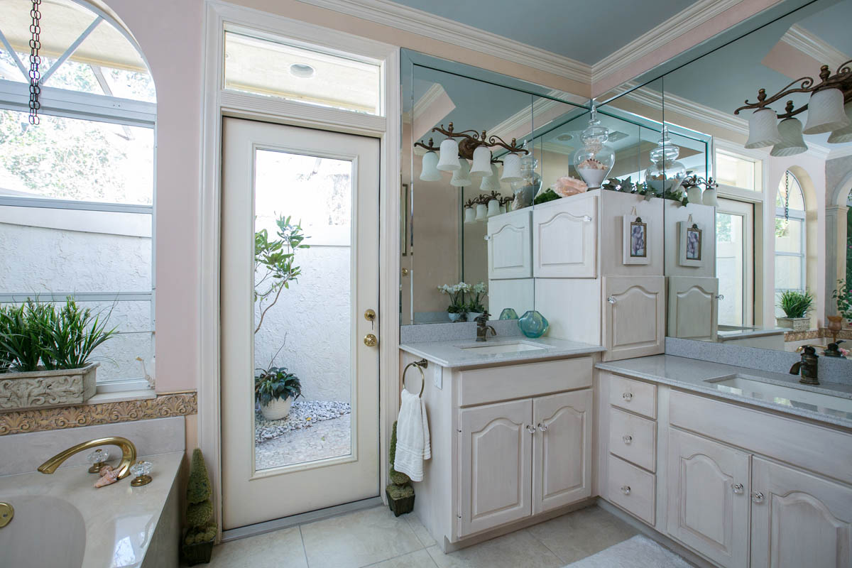 The master bath features his and hers sinks a large tub and an enclosed and screened outdoor shower.  