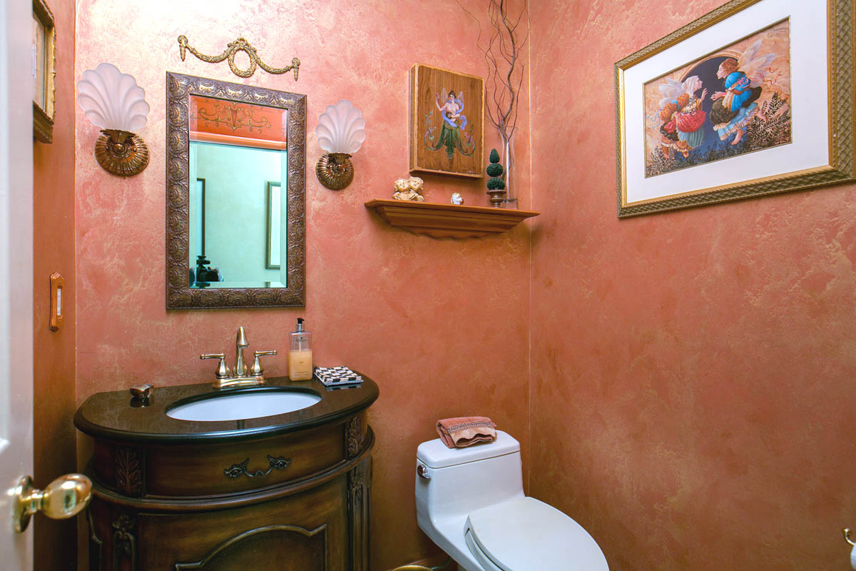 The powder room with faux finished walls crown molding and custom vanity.               