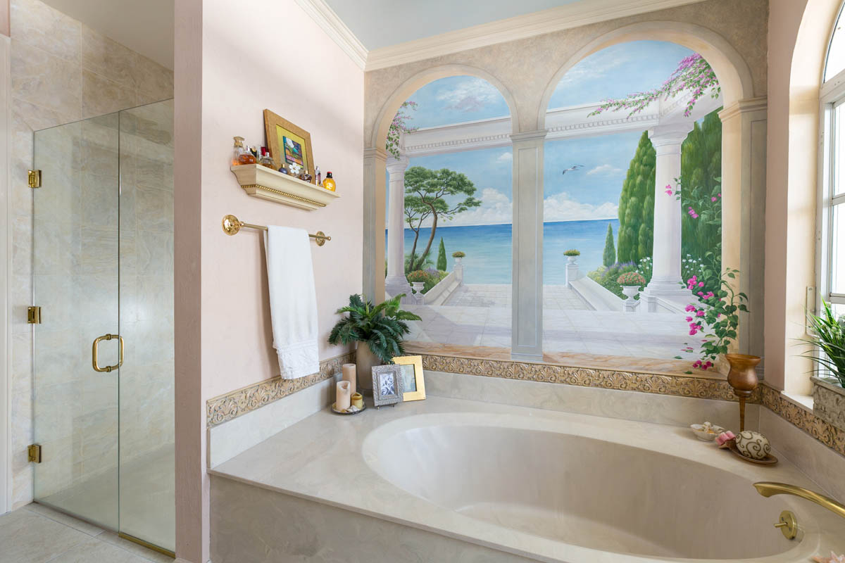 There is a glass enclosed shower and a beautiful Trompe l’oeil mural over the tub that adds a great dimension to the space.   