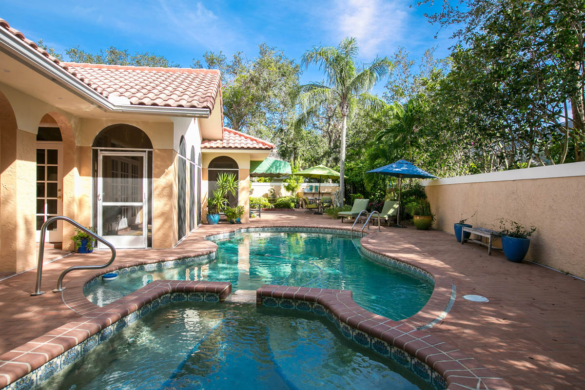 A view from the pool spa into the screened porch and the east side of the paved back yard.                  