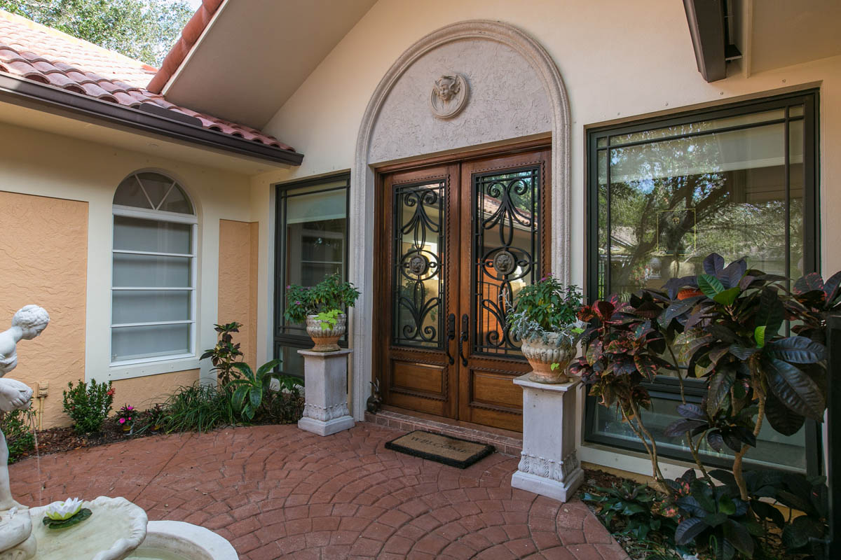 A water fountain in the front court, the custom designed front door accented by a nice archway welcomes you into the residence.       