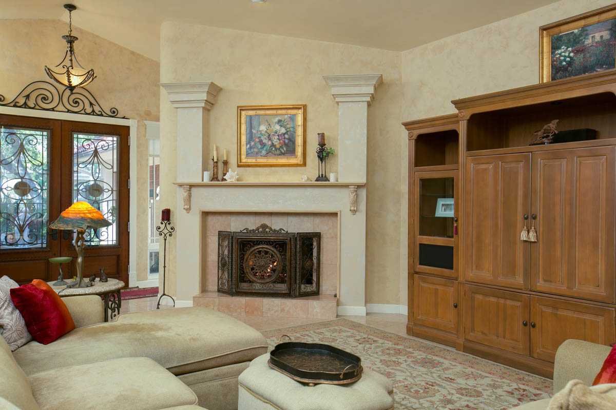 The fireplace is adorned by custom designed columns and mantel.        
