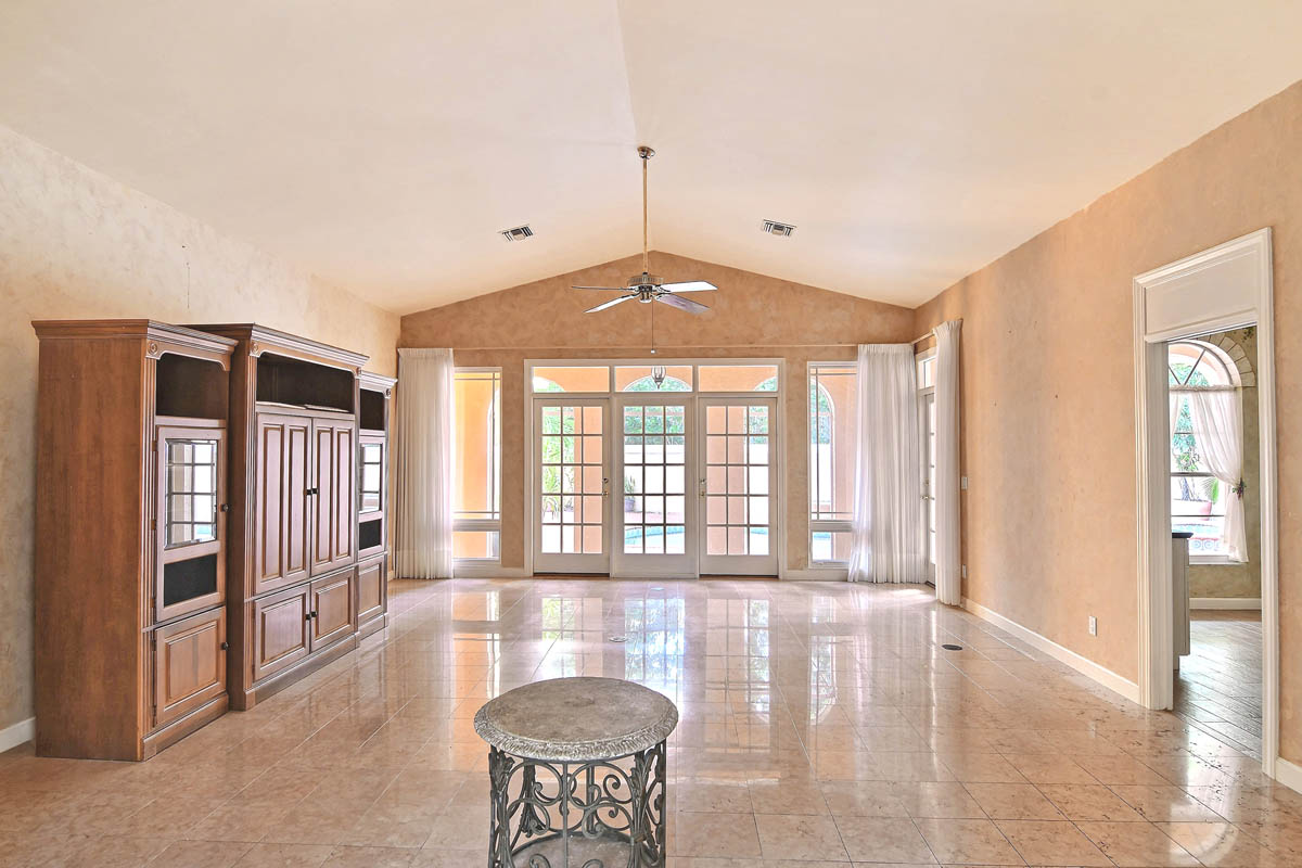 Great Room (unfurnished) with French Doors opening up into the screened porch and pool patio.                      